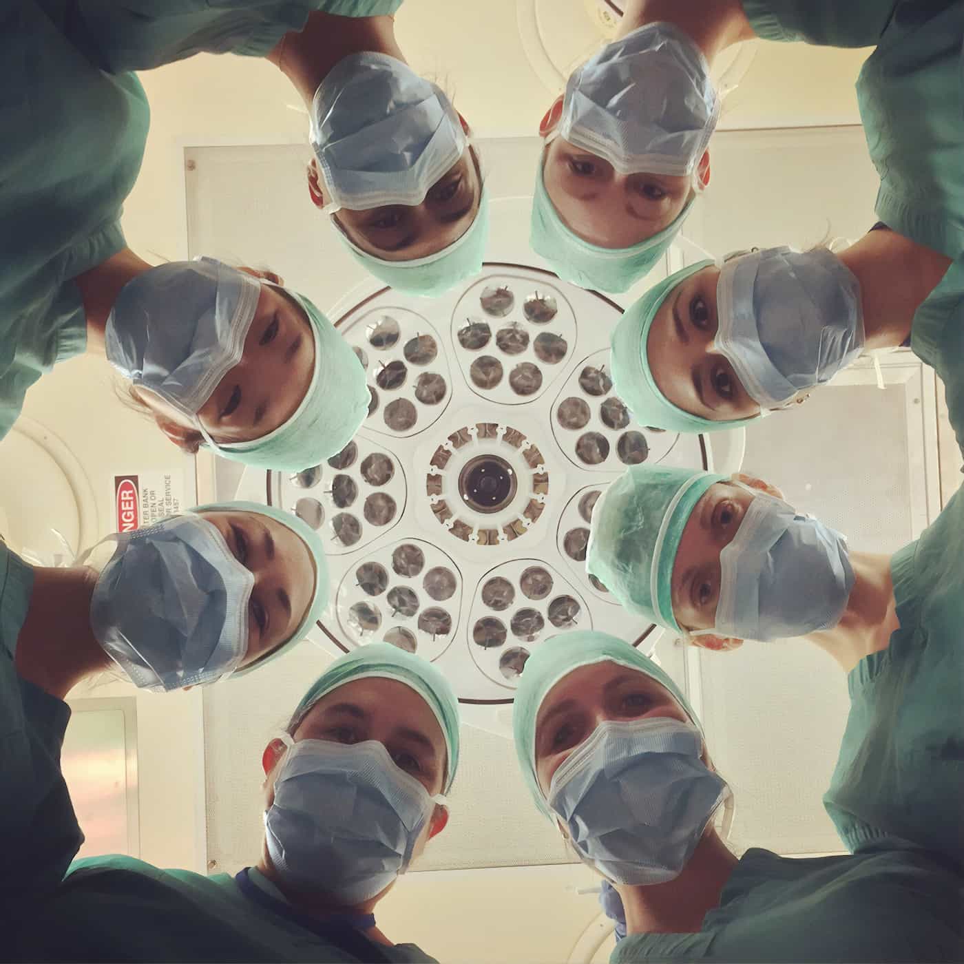 picture of a geoup of doctors in operationg gear looking down